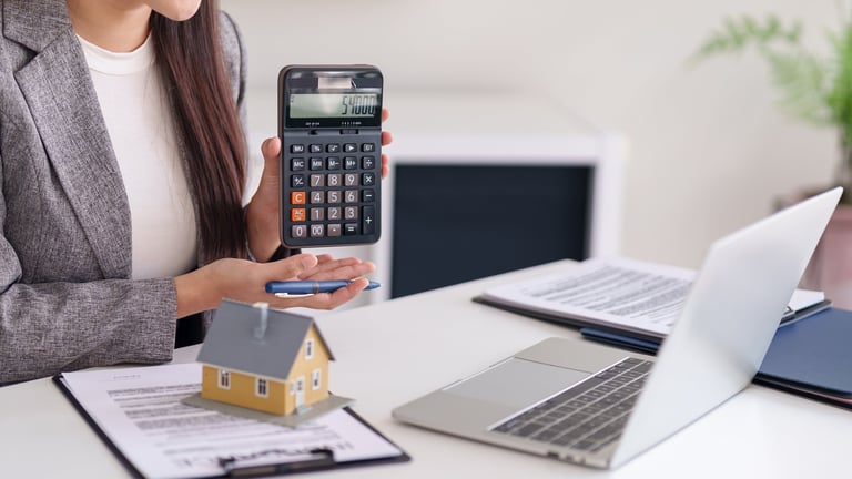 Professional Asian woman real estate consultant performs precise financial calculations for home purchase property investment mortgage planning business