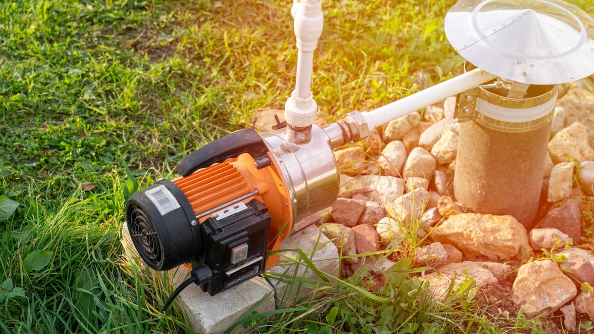 Drinking water well and electric pump close-up. Extraction of surface groundwater from a well