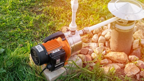 Drinking water well and electric pump close-up. Extraction of surface groundwater from a well
