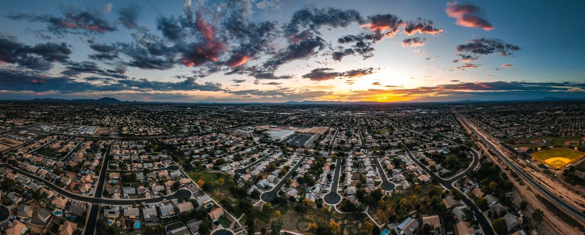 Aerial pano over a suburban Phoenix neighborhood, at dusk.