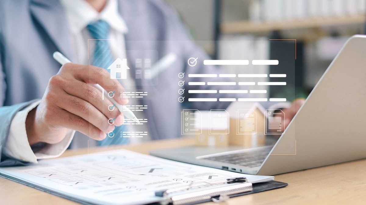 Businessman reviewing digital checklist for property and asset document approval using tablet and laptop. Concept of verification process, asset management, and business workflow control.