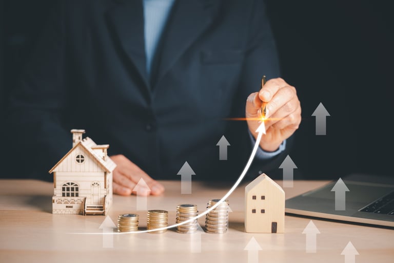 Businessman drawing rising arrow over coins, house models, showing real estate investment growth, mortgage savings, increasing property value for finance, housing market, planning. investment growth
