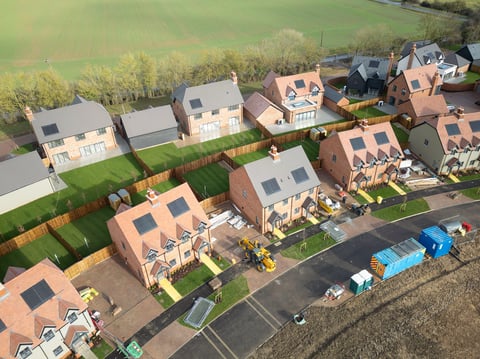 Interesting drop UAV view of near completed semi detached homes on a new housing development site