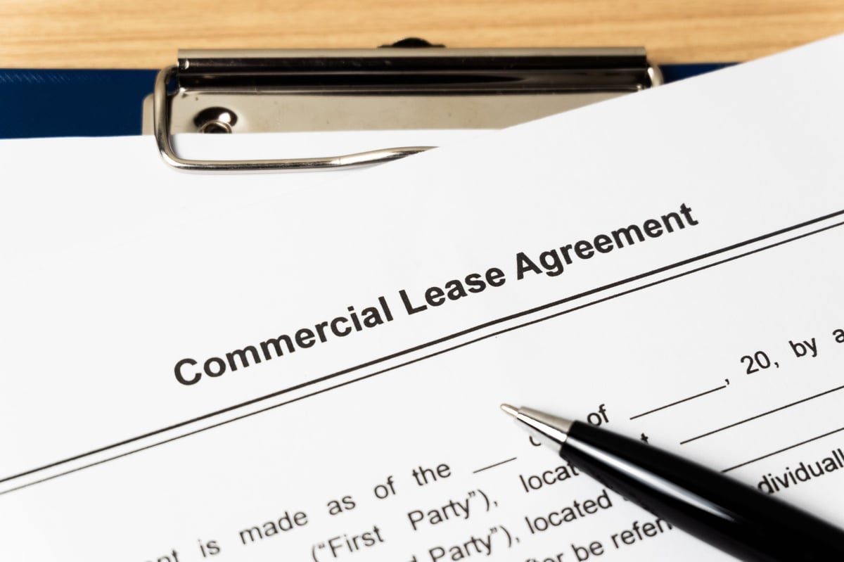 Legal document Commercial Lease Agreement on paper with pen