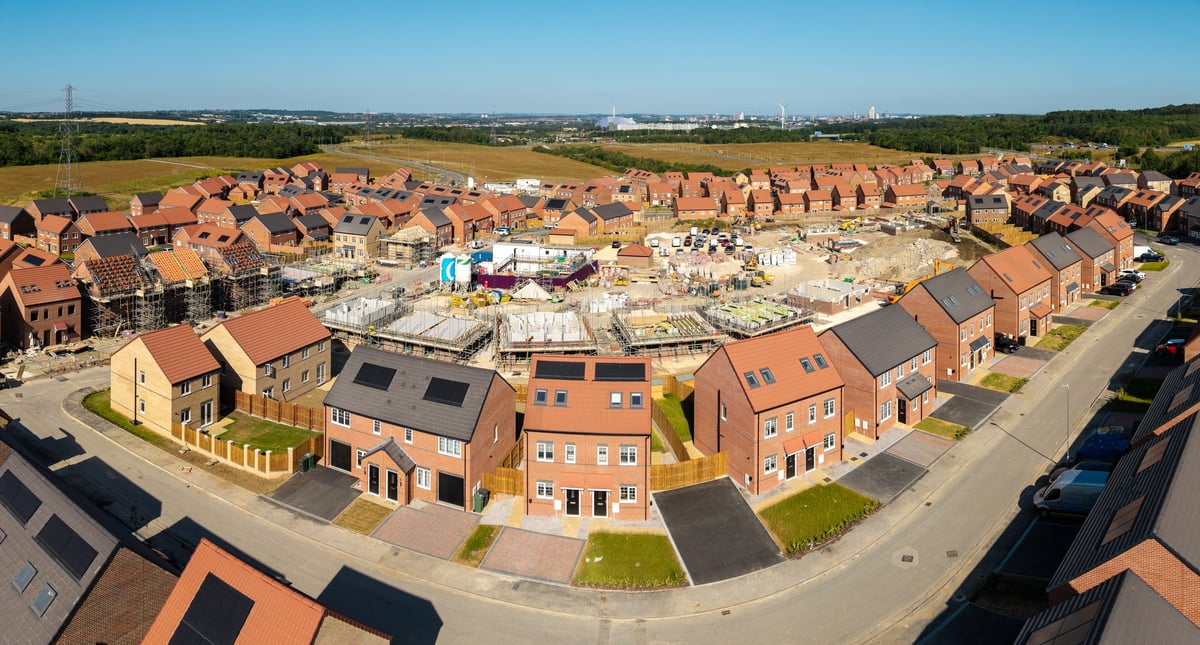 Aerial view of new build houses and homes under construction. New homes on green belt land to tackle the UK housing shortage
